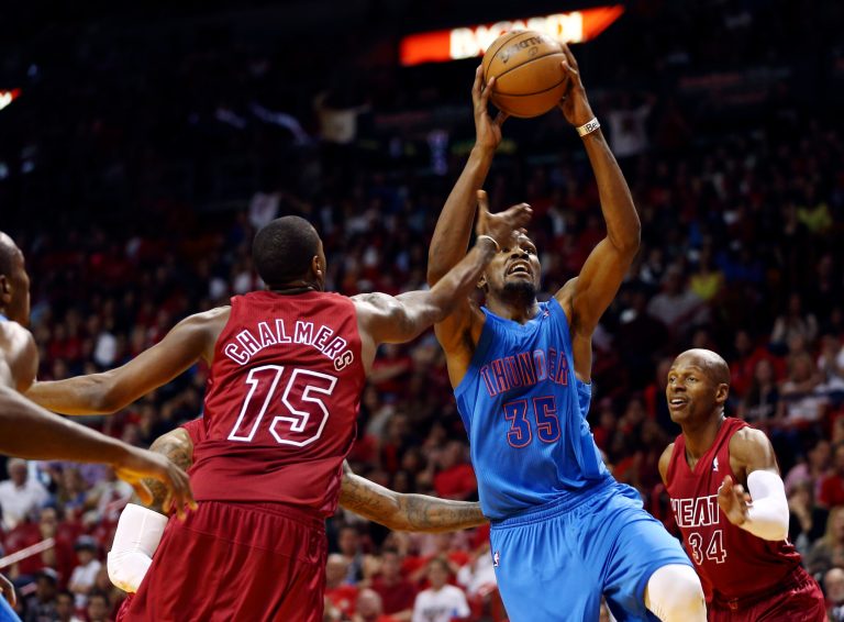   Miami Heat's Mario Chalmers (15) and Ray Allen (34) defend against Oklahoma Cty Thunder's Kevin Durant during the second half of an NBA basketball game in Miami, Tuesday, Dec. 25, 2012. The Heat won 103-97. (AP Photo/J Pat Carter)  