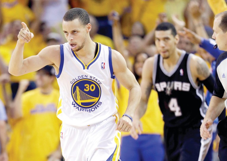 Marcio Jose Sanchez/AP
Warriors guard Stephen Curry scored 22 points on an injured left ankle as his team beat the Spurs to tie their series at 2-2 on Sunday.