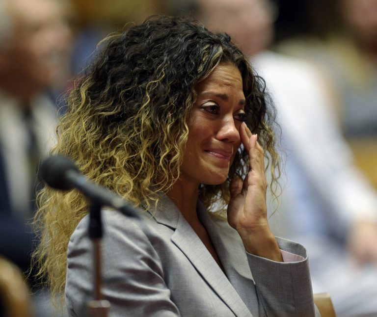   Bethany Fraser, a family member affected by phone rates, listens to testimony during the Federal Communications Commission (FCC) hearing at the FCC in Washington, Friday, Aug. 9, 2013. The FCC approved limits on rates that prison inmates pay to make phone calls. The FCC voted 2-1 Friday - a decade after inmates' families asked for action. Fraser is a family member impacted by the high phone rates for prison inmates. (AP Photo/Susan Walsh)  