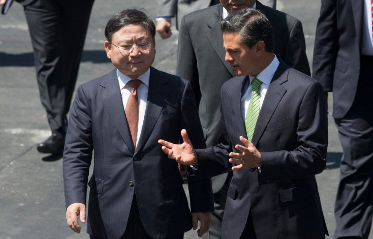 KIA Vice Chairman and CEO Hyoung-Keun Lee, left, and Mexico's President Enrique Pena Nieto talk before an announcement regarding a new KIA Auto assembly plant to be set up in Wednesday, Aug. 27, 2014. KIA announced the construction of a new auto making plant in the northern state of Nuevo Leon which is slated to start operating in 2016. (AP Photo/Eduardo Verdugo)