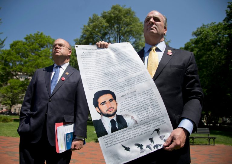 Rep. Dan Kildee, D-Mich., right, accompanied by Rep. James McGovern, D-Mass., holds a poster with the image and story of one of his constituents, Amir Hekmati, a former Marine incarcerated in Iran since 2011, during a gathering in Lafayette Park across the street from the White House in Washington, Monday, May 19, 2014, with family members and supporters calling for Hekmati's release.  (AP Photo/Carolyn Kaster)
