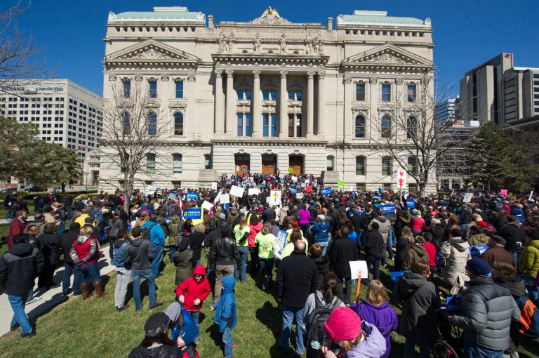 Thousands of opponents of Indiana Senate Bill 101, the Religious Freedom Restoration Act, gathered on the lawn of the Indiana State House to rally against that legislation Saturday, March 28, 2015. Indiana's law has been widely criticized by businesses and organizations around the country. (AP Photo/Doug McSchooler)