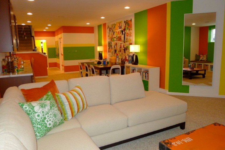This basement was transformed into a family/playroom with space for both kids and adults. The colors are bright enough for a child, but not too 