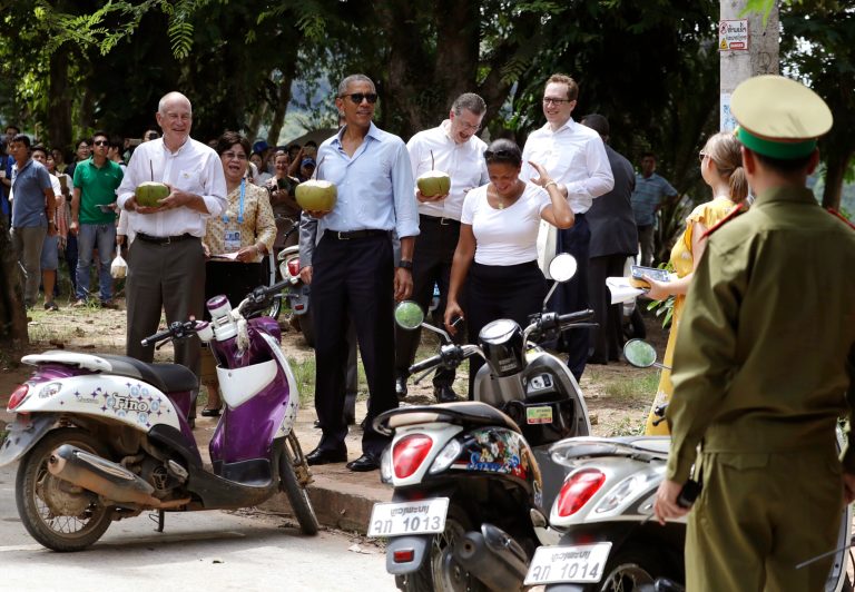 U.S. President Barack Obama, center, and, U.S. Ambassador to Laos Daniel Clune, left, with fresh coconuts, and National Security Adviser Susan Rice, right, stand together after looking at the Mekong River the Luang Prabang, Laos, Wednesday, Sept. 7, 2016. (AP Photo/Carolyn Kaster)
