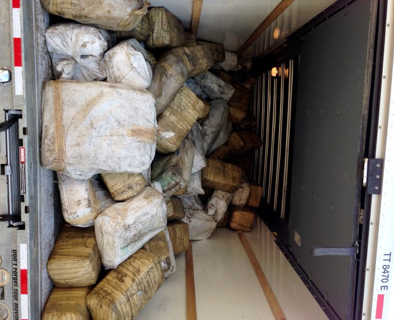 This Wednesday, July 9, 2014 photo provided by the Bakersfield Police Department shows the interior of a seized truck near Bakersfield, Calif. Police said Thursday, July 10, 2014 they seized more than 3 tons of packaged marijuana after pulling over a U-Haul driver who ran a red light. Officers cut the lock on the truck, and said they found over 6,000 pounds of marijuana in plastic-wrapped bales. (AP Photo/Bakersfield Police Department)
