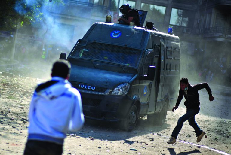 Egyptian protesters clash with security forces near Tahrir square, in Cairo, Egypt, Wednesday, Nov. 28, 2012. Egyptian state television says the country's highest appeal court has decided to suspend its work nationwide to protest the president's decrees giving himself nearly absolute powers. (AP Photo/Khalil Hamra)