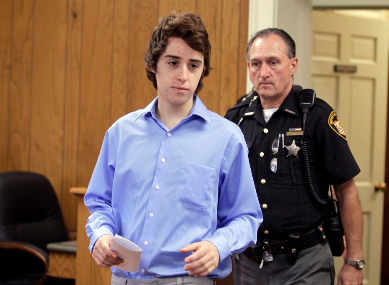   T.J. Lane is brought in to court for his arraignment by sheriff's deputies in Chardon, Ohio Friday, June 8, 2012. Lane pleaded not guilty to six charges for a shooting at Chardon High School in February that left three students dead and three wounded. Lane will be tried as an adult. The teen could face life in prison if he's convicted. (AP Photo/Mark Duncan)  
