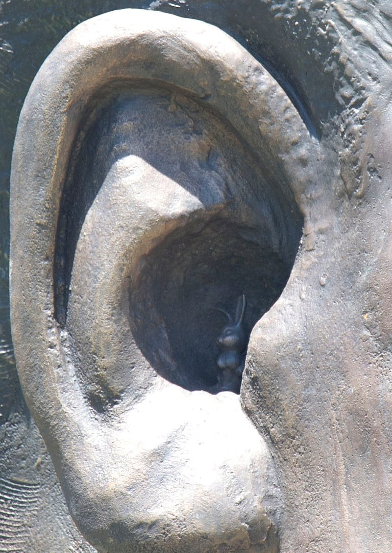 In this photo taken Wedensday, Jan. 16, 2014 a new, 9-meter (29.5-foot) sculpture of Nelson Mandela, with a  barely visible sculpted rabbit tucked inside one of the bronze ears. The statue is billed as the biggest statue of the South African leader. Officials want the miniature bunny removed from the statue, which was unveiled outside the government complex in Pretoria, the capital, on Dec. 16, a day after Mandela's funeral. (AP Photo)
