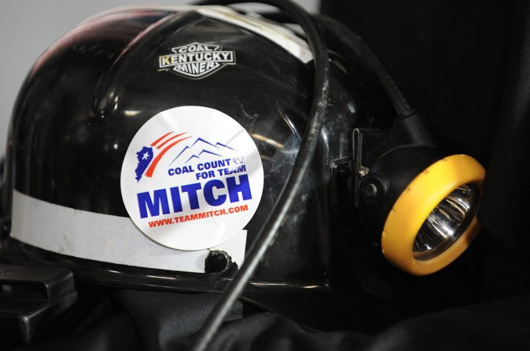 A Coal Country for Team Mitch election sticker is on a coal miners helmet on a stage that Senate Minority Leader Mitch McConnell of Ky. was speaking during a campaign stop at Badgett Supply in Madisonville, Ky.  (AP Photo/Stephen Lance Dennee)