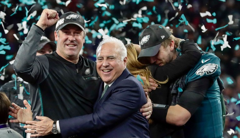 Philadelphia Eagles head coach Doug Pederson celebrates with the Eagles owner Jeffrey Lurie, as quarterback Nick Foles hugs his wife, Tori, after winning the NFL Super Bowl 52 football game against the New England Patriots in Minneapolis. The Eagles won 41-33. (AP Photo/Frank Franklin II)
