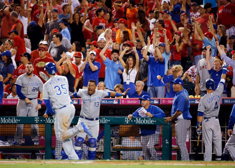 Fans cheer as Kansas City Royals players celebrate after Eric Hosmer (35) hit a two-run home run against the Los Angeles Angels in the 11th inning of Game 2 of baseball's AL Division Series in Anaheim, Calif., Friday, Oct. 3, 2014. The Royals won 4-1. (AP Photo/Lenny Ignelzi)