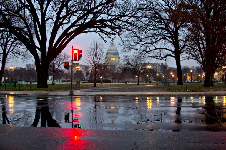 Snow and freezing rain fall on the Capitol in Washington, early Tuesday, Dec. 10, 2013, prompting the federal government to close for the wintry weather. (AP Photo/J. Scott Applewhite)