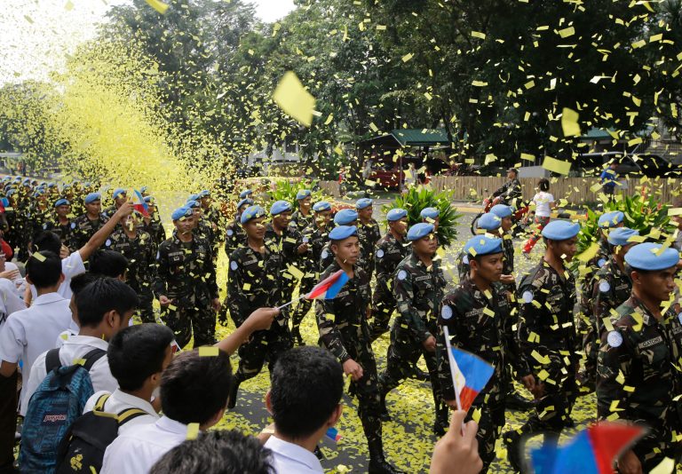 Confetti rain on marching Filipino UN Peacekeepers as they are given a heroes welcome Wednesday, Oct.1, 2014 at Camp Aguinaldo at suburban Quezon city northeast of Manila, Philippines. In a separate ceremony at the Presidential Palace earlier, Philippine President Benigno Aquino III says his government will no longer deploy troops to security hotspots in the world where they can face unclear or impossible U.N. peacekeeping missions like in the Golan Heights, where Filipino forces came under attack by al-Qaida-linked insurgents. Aquino III said Wednesday hundreds of Filipino peacekeepers were tasked to guard a buffer zone separating Israel and Syria. But when the current Syrian conflict spilled over into the buffer zone and anti-government Islamic militants started attacking the Filipino peacekeepers, their mission became unclear.(AP Photo/Bullit Marquez)