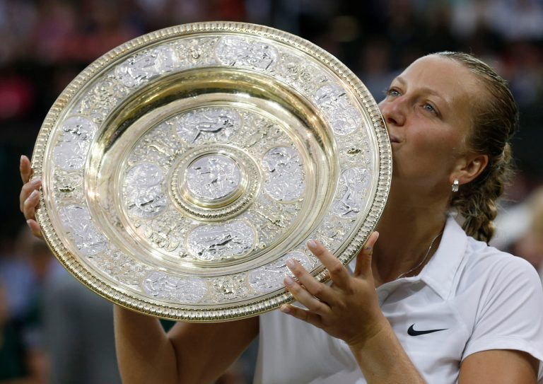 Petra Kvitova of Czech Republic kisses the trophy after winning the women's singles final against Eugenie Bouchard of Canada at the All England Lawn Tennis Championships in Wimbledon, London, Saturday July 5, 2014. (AP Photo/Sang Tan)