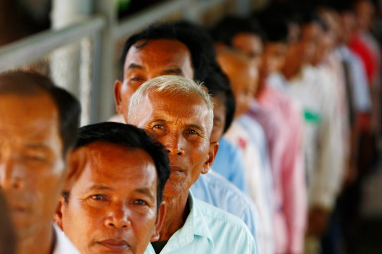 Cambodians line up at a court entrance before a hearing to prepare for the genocide trial of two surviving leaders Khieu Samphan and Noun Chea, at the U.N.-backed war crimes tribunal in Phnom Penh, Cambodia, Wednesday, July 30, 2014. (AP Photo/Heng Sinith)