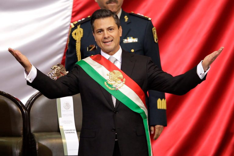   Mexico's incoming President Enrique Pena Nieto spreads out his arms after being sworn in at the inauguration ceremony in National Congress, in Mexico City, Saturday, Dec. 1, 2012. Pena Nieto took the oath of office as Mexico's new president on Saturday, bringing the old ruling party back to power after a 12-year hiatus amid protests inside and outside the congressional chamber where he swore to protect the constitution and laws of the land. (AP Photo/Alexandre Meneghini)  