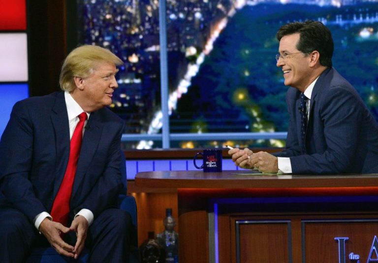 In this photo provided by CBS, Republican presidential candidate Donald Trump, left, joins host Stephen Colbert on the set of 