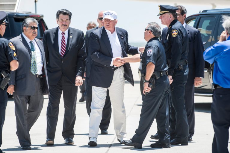 Republican Presidential candidate and business mogul Donald Trump shakes hands with local police during his trip to the border on July 23, 2015 in Laredo, Texas. (Photo by Matthew Busch/Getty Images)