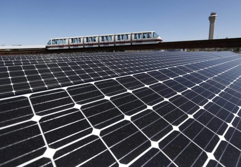 Solar panels on the roof of the building supplying energy to the AirTrain at Newark Liberty International Airport are seen as the train rolls by.