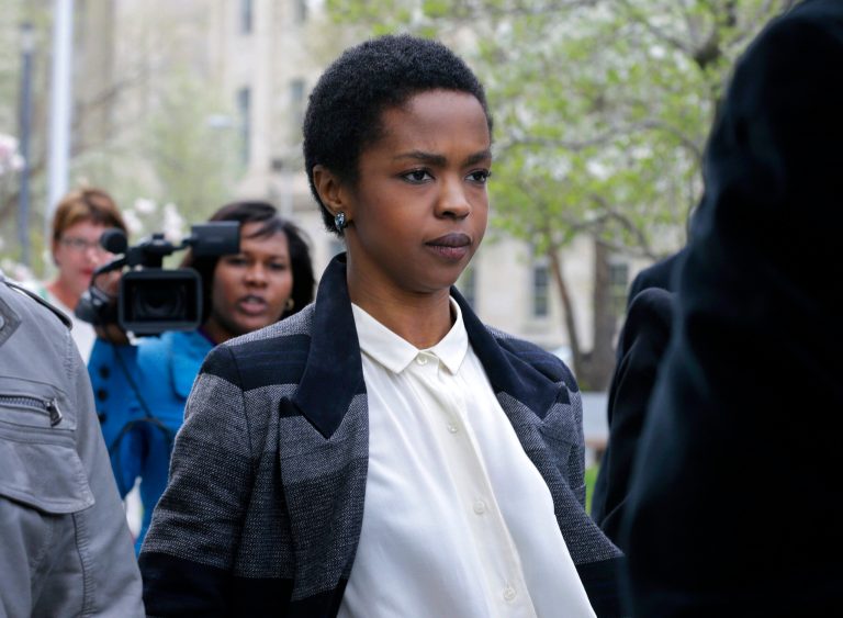 FILE - This April 22, 2013 file photo shows singer Lauryn Hill walking from federal court in Newark, N.J. Hill is facing sentencing Monday, May 6, on federal tax charges. Hill pleaded guilty last year to not paying federal taxes on $1.8 million earned from 2005 to 2007. A judge two weeks ago said Hill had paid only about $50,000 of more than $500,000 she owes. Hill said she has signed a recording contract with Sony that will help her pay her taxes. Citing the legal deadline, she made a song available on iTunes over the weekend. She faces up to a year in prison on each of three counts. Her attorney is seeking probation for her. (AP Photo/Mel Evans, file)
