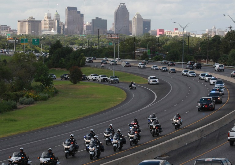 The funeral procession for former Elmendorf Police Chief Michael Pimentel winds its way north Tuesday, Sept. 2, 2014. Pimentel was shot to death during a traffic stop. (AP Photo/San Antonio Express-News, John Davenport) MAGS OUT NO SALES SAN ANTONIO OUT