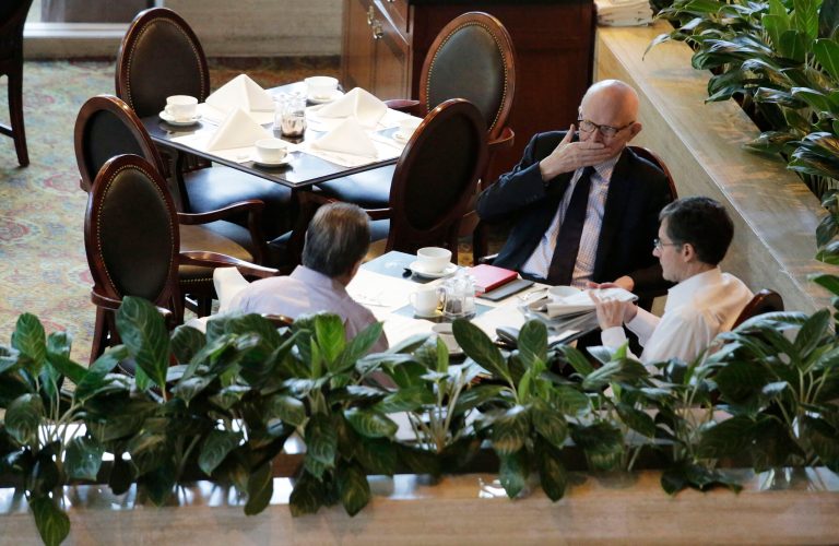 Former U.S. special envoy for North Korea policy Stephen Bosworth, top, Joseph DeTrani, bottom right, and Tony Namkung, left, meet during breakfast ahead of meetings with North Korean officials, Sunday, Jan. 18, 2015, in Singapore. North Korea's chief nuclear envoy and former U.S. negotiators and security experts were in Singapore to discuss nuclear issues at meetings that started Sunday and will be held over two days. (AP Photo/Wong Maye-E)