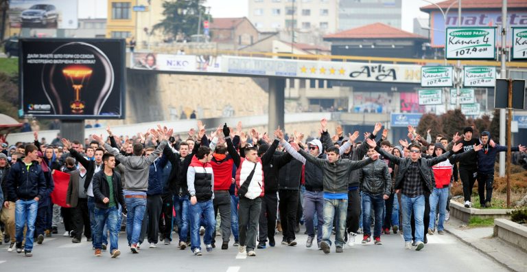 A group of ethnic Albanians protest through a street in Skopje, Macedonia, on Saturday, March 2, 2013, as they show their support for newly named defence minister Talat Xhaferi, and as a contra-protest to Macedonian protests overnight Friday when scuffles broke out with police. A series of scuffles erupted late on Friday and continued over night when a group of a few hundred Macedonians started protesting against the designation of the new defense minister Talat Xhaferi, an ethnic Albanian and former rebel commander. (AP Photo/Vangel Tanurovski)