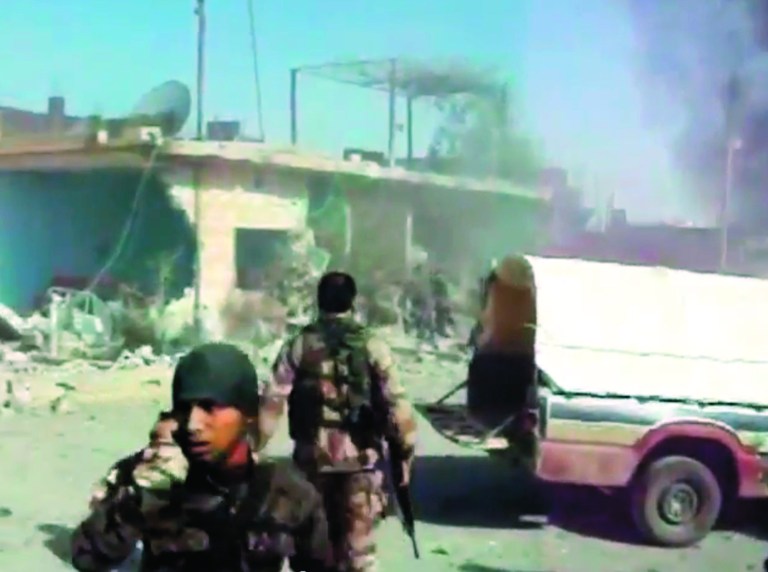 This image taken from video obtained from Shaam News Network, which has been authenticated based on its contents and an Associated Press journalist who saw a plane bomb an area around the Syrian-Turkish border town of Ras al-Ayn, shows Syrians rebels inspecting the damage moments after an airstrike by Syrian warplanes in Ras al-Ayn, Syria, Monday, Nov. 12, 2012. (AP Photo/Shaam News Network via AP video)