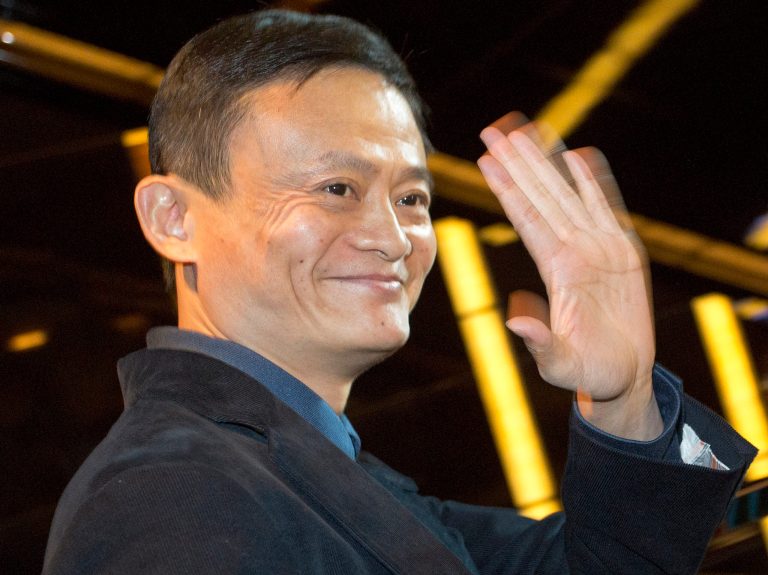FILE -In this Sept. 15, 2014 file photo, Alibaba Group founder and Executive Chairman Jack Ma waves to reporters before an IPO road show at a hotel in Hong Kong. When Jack Ma founded Alibaba 15 years ago he insisted the e-commerce venture should see itself as competing against Silicon Valley, not other Chinese companies. That bold claim from a time when China was still a corporate backwater has been vindicated by Alibaba completing a mammoth sale of shares to investors in the U.S. and elsewhere. The shares start trading in New York on Friday, Sept. 19, 2014. (AP Photo/Vincent Yu, File)