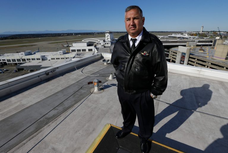 Capt. Oscar Vela stands on a rooftop at Seattle-Tacoma International Airport, Monday, Oct. 28, 2013, in Seattle. The modernization of the U.S. air traffic control system, one of the governmentâs most ambitious and complex technology programs, is in trouble. The Next Generation Air Transportation System, or NextGen, was sold to Congress and the public by the Federal Aviation Administration a decade ago as a way to accommodate an anticipated surge in air travel, reduce fuel consumption and improve safety and efficiency. (AP Photo/Ted S. Warren)