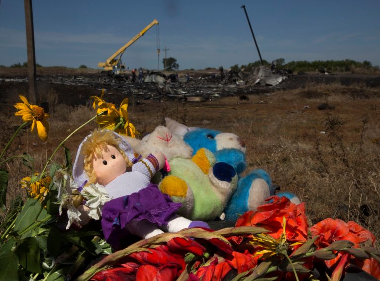 Toys and flowers are placed at the crash site of Malaysia Airlines Flight 17 near the village of Hrabove, eastern Ukraine, Donetsk region, eastern Ukraine Monday, July 21, 2014. Another 21 bodies have been found in the sprawling fields of east Ukraine where Malaysia Airlines Flight 17 was downed last week, killing all 298 people aboard. (AP Photo/Dmitry Lovetsky)