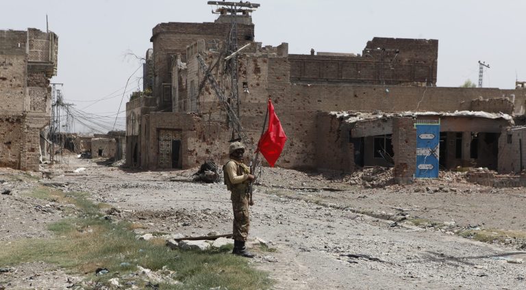 A Pakistani army soldier stands guard in Miran Shah bazaar after driving out militants from Pakistan's tribal region of North Waziristan along the Afghanistan border, Wednesday, July 9, 2014. Roughly 800,000  people left North Waziristan ahead of the ground operation, raising concerns of a humanitarian catastrophe as they reached nearby areas. (AP Photo/Rebecca Santana)