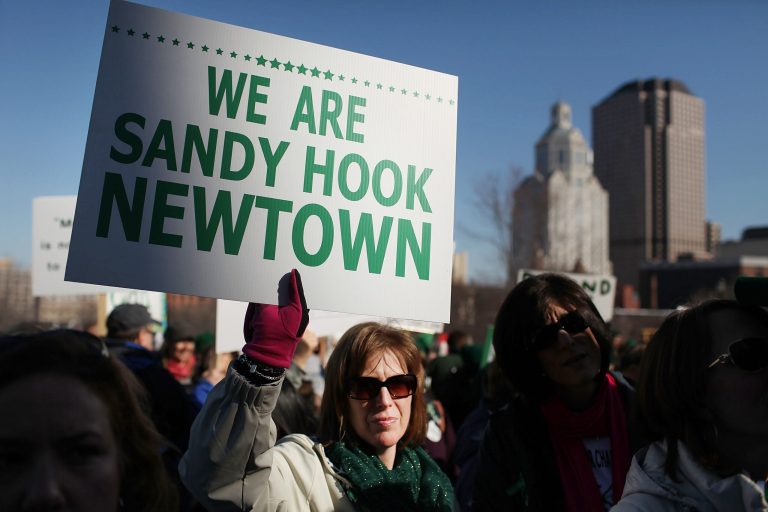 HARTFORD, CT - FEBRUARY 14:  A woman holds up a sign during a rally at the Connecticut State Capital to promote gun control legislation in the wake of the December 14, 2012, school shooting in Newtown on February 14, 2013 in Hartford, Connecticut. Referred to as the 