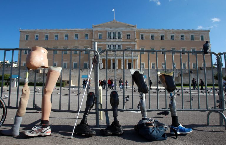   Disabled protesters line up prosthetic limbs outside Greece's parliament in Athens, Monday, Dec. 3, 2012. The protest was part of European demonstrations to mark International Day for People with Disabilities on Monday. Greek campaigners say recent austerity cuts have left many disabled Greeks struggling to receive proper care and state support. (AP Photo/Thanassis Stavrakis)  