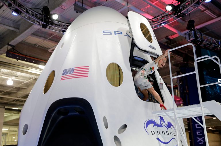 Invited guest Robin Lee walks out of the cabin of the SpaceX Dragon V2 spacecraft at the SpaceX headquarters on May 29, 2014, in Hawthorne, California.