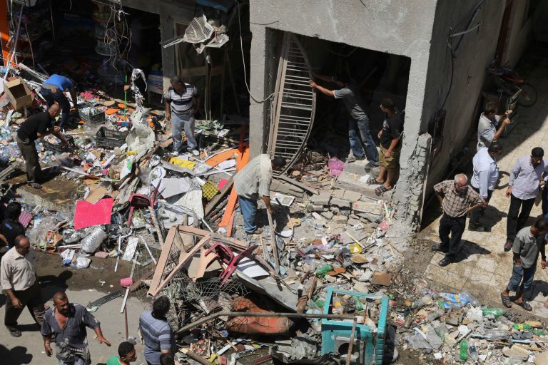 Civilians inspect the site of a car bomb attack in Baghdad, Iraq on Aug. 13. (AP/Karim Kadim)