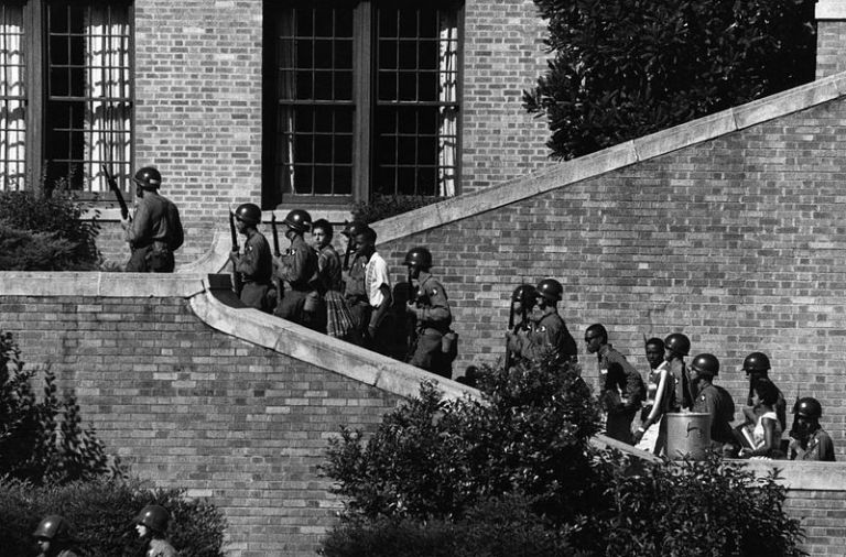 Soldiers from the 101st Airborne Division escort the African-American students known as the 