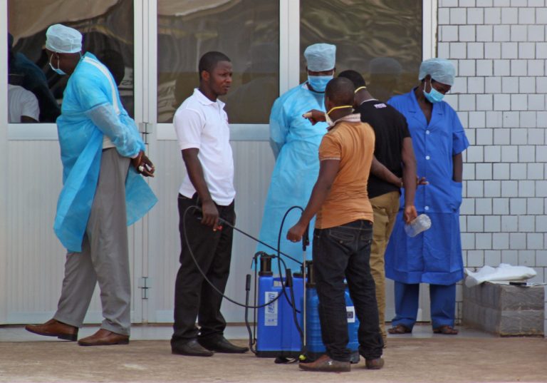 In this photo taken on Saturday, March 29, 2014, medical personnel at the emergency entrance of a hospital receive suspected Ebola virus patients in Conakry, Guinea. Senegal has closed its land border with neighboring Guinea to prevent the spread of the Ebola outbreak, which has killed at least 70 people. Senegal's Interior Ministry announced the border closure Saturday. It also said officials in the southern region of Kolda closed a weekly market which draws thousands of people from the neighboring West African countries of Guinea, Gambia and Guinea-Bissau. Guinea confirmed last week that several victims of hemorrhagic fever in the country's southern region had tested positive for Ebola. (AP Photo/ Youssouf  Bah)