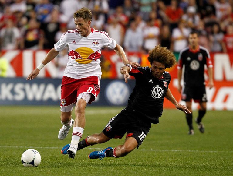 HARRISON, NJ - JUNE 24:  Jan Gunnar Solli #8 of the New York Red Bulls drives by Nick DeLeon #18 of the D.C. United during their match at Red Bull Arena on June 24, 2012 in Harrison, New Jersey.  (Photo by Jeff Zelevansky/Getty Images)