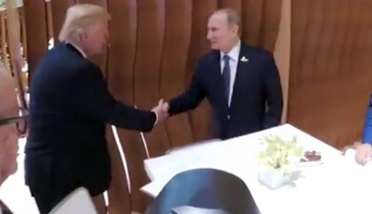 President Trump, left, shakes hand with the Russian President Vladimir Putin during the G-20 summit in Hamburg Germany. (Steffen Kugler/German Government via AP)
