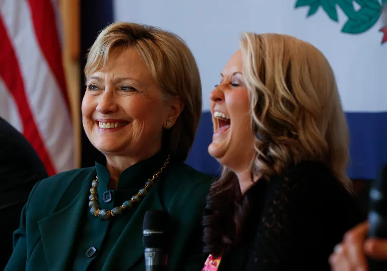 Democratic presidential candidate Hillary Clinton laughs with recovering drug addict Chelsea Carter, right, during a campaign stop in Charleston, W.V., Tuesday, May 3, 2016. (AP Photo/Paul Sancya)
