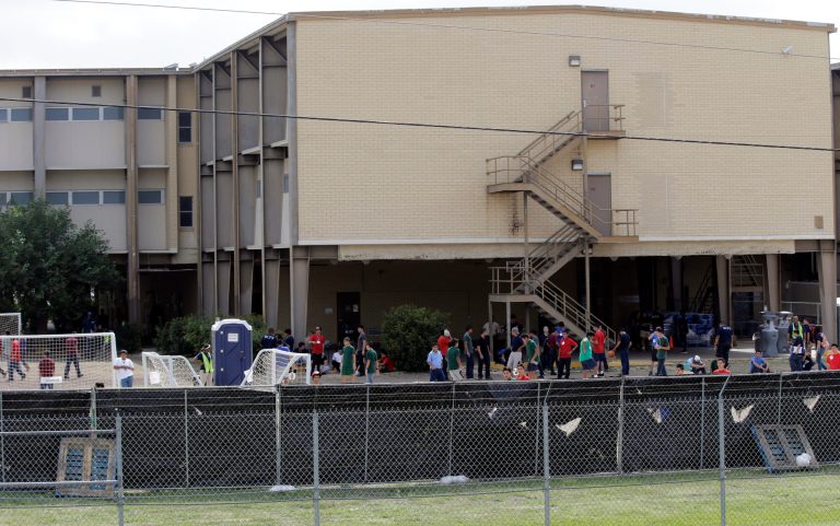 FILE - This June 23, 2014 file photo shows a temporary shelter for unaccompanied minors who have entered the country illegally at Lackland Air Force Base in San Antonio. The government said Monday it will soon close three emergency shelters it established at U.S. military bases to temporarily house children caught crossing the Mexican border alone. It said fewer children were being caught and other shelters will be adequate.  (AP Photo/Eric Gay, File)