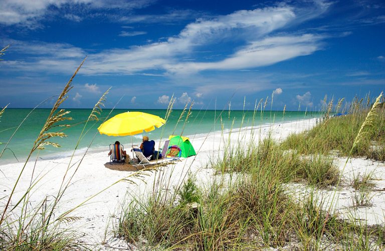   This undated photo provided by the Sanibel & Captiva Chamber of Commerce shows visitors on the West Gulf Beach on Sanibel Island in Florida. The Gulf Coast barrier island is known for quiet beaches, seashells and wildlife and its high season for tourism begins mid-January, peaking mid-March to mid-April. (AP Photo/Sanibel & Captiva Chamber of Commerce/David Meardon Photography)  