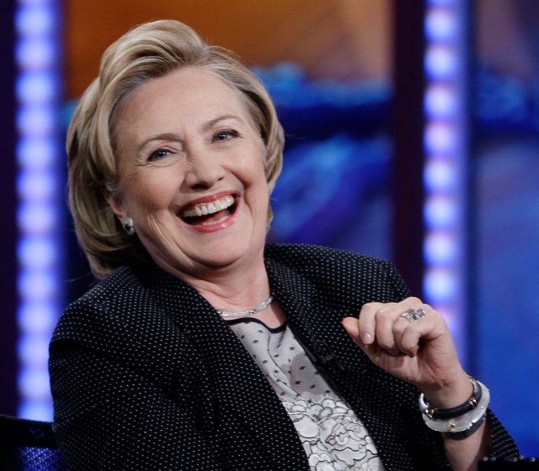 In this July 15, 2014, photo, former U.S. Secretary of State Hillary Rodham Clinton reacts to host Jon Stewart during a taping of 