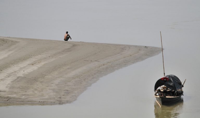 An Indian man urinates on the banks of the River Brahmaputra in Gauhati, India, Friday, Oct. 10, 2014. India is considered to have the world's worst sanitation record despite spending some $3 billion since 1986 on sanitation programs, according to government figures. Building toilets in rural India, where hundreds of millions are still defecating outdoors, will not be enough to improve public health, according to a study published Friday. (AP Photo/Anupam Nath)