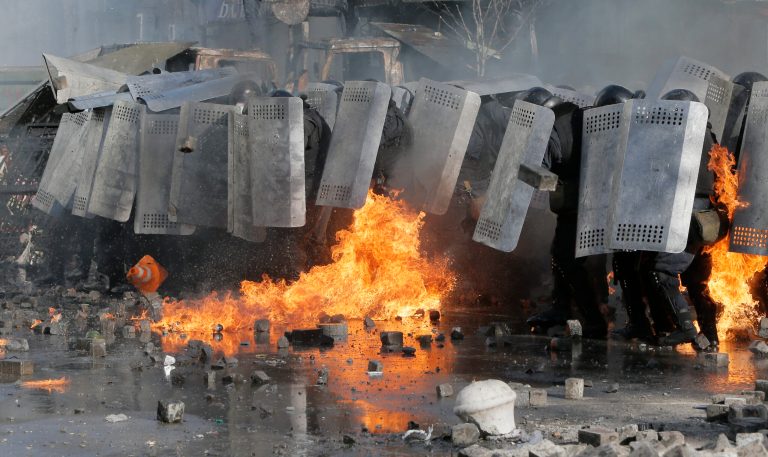 Riot police clash with anti-government protesters outside Ukraine's parliament in Kiev, Ukraine, Tuesday, Feb. 18, 2014. Some thousands of anti-government protesters clashed with police in a new eruption of violence Tuesday. (AP Photo/Efrem Lukatsky)