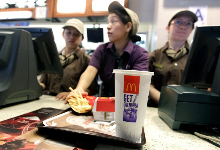   McDonald's employees serve a meal containing a large soda, Tuesday, June 12, 2012, in New York. Mayor Michael Bloomberg's proposal to ban large sugary drinks from New York City eateries is moving forward. The health board voted unanimously Tuesday to begin a public comment period on the new rule. A formal vote on approval will come later, but several board members spoke strongly in favor of the plan. (AP Photo/Mary Altaffer)  