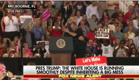 Supporter invited on stage, gives Trump a big hug