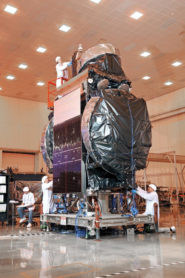   This May 1, 2012 photo provided by Orbital Sciences via the East Valley Tribune shows workers at the Satellite Manufacturing Facility in Gilbert, Ariz., working on the newest LandSat satellite. The satellite will be launched in February to circle the globe collecting data for NASA and the Department of Interior. (AP Photo/Orbital Sciences via the East Valley Tribune) ARIZONA REPUBLIC OUT  