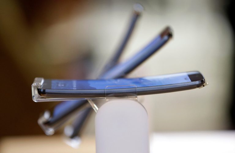 FILE - In this Tuesday, Nov. 5, 2013, file photo, LG Electronics's smartphone G Flex is displayed during a media event at its head office in Seoul, South Korea. LG Electronics Inc. reports its fourth-quarter financial results on Monday, Jan. 27, 2014. (AP Photo/Lee Jin-man, File)